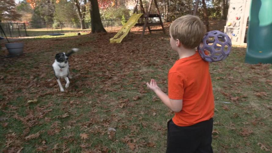 Aleric Crump plays with dog