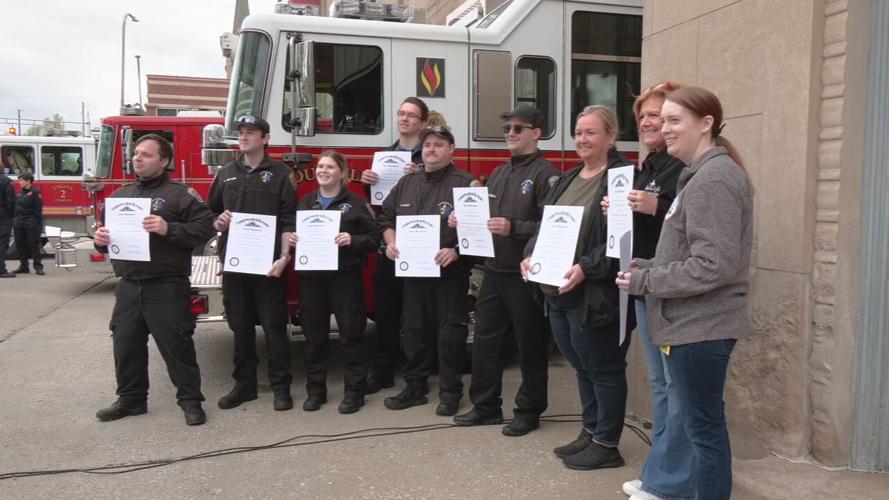 Louisville firefighters pose with Kentucky Colonel certificates