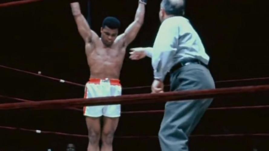 Muhammad Ali in ring with arms raised