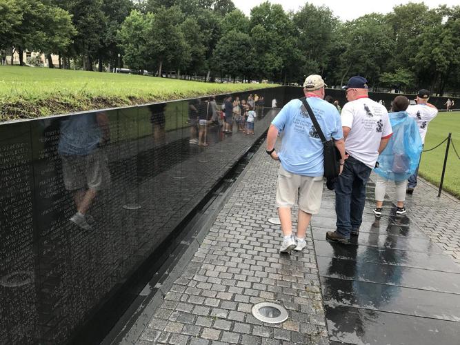 Honor Flight Bluegrass Vets Walk Near Wall