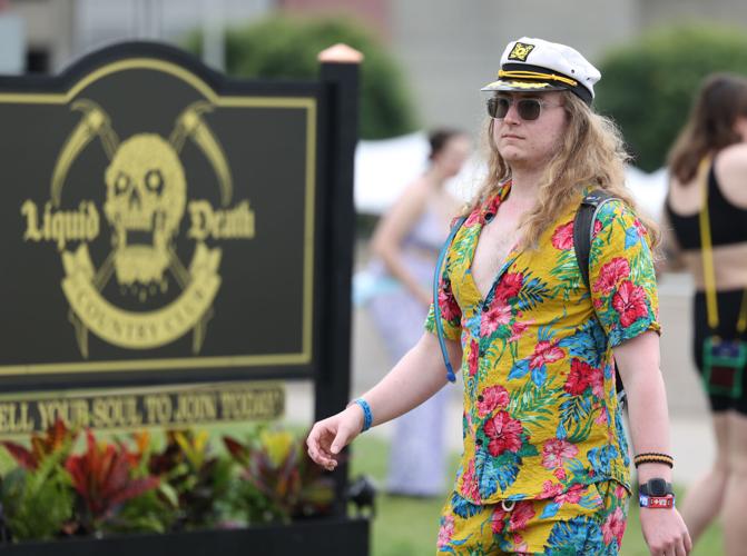 A person with a sailor's hat walks into Forecastle.JPG