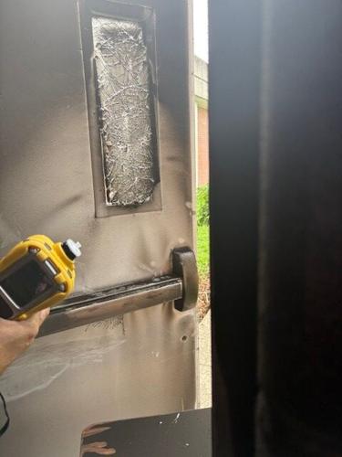 Moore HighSchool fire - door broken into.jpg