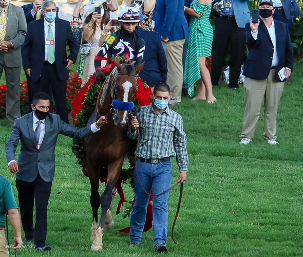 Authentic, ridden by jockey John Velasquez, heads to the Winner's Circle