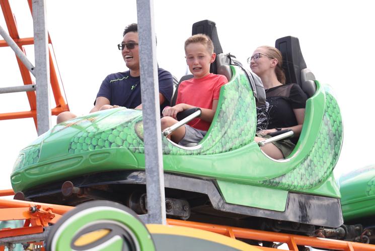 People ride on the Midway rides