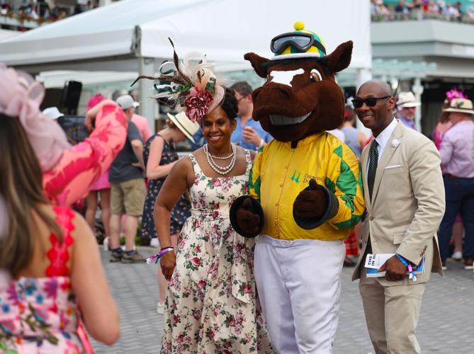 People pose with horse mascot at churchill downs.JPG