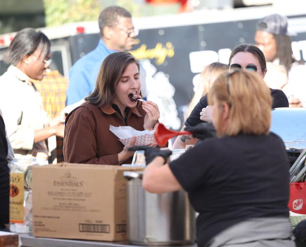 Louisville's Great Chili Cook off - woman tries sample.JPG