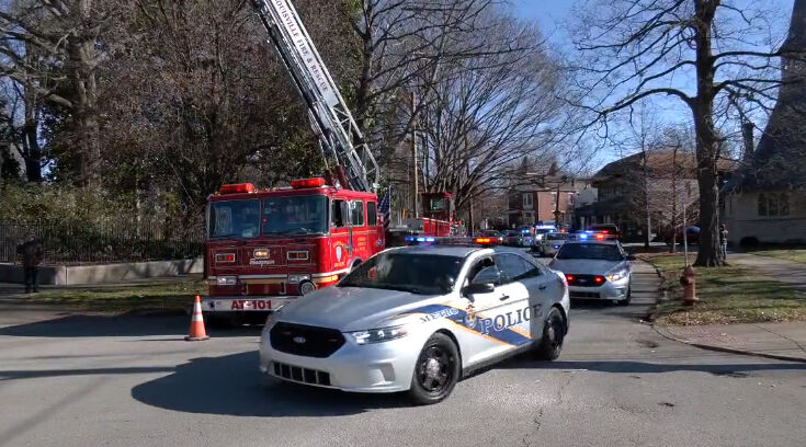 Cottongim procession - lmpd vehicle with fire truck.jpg