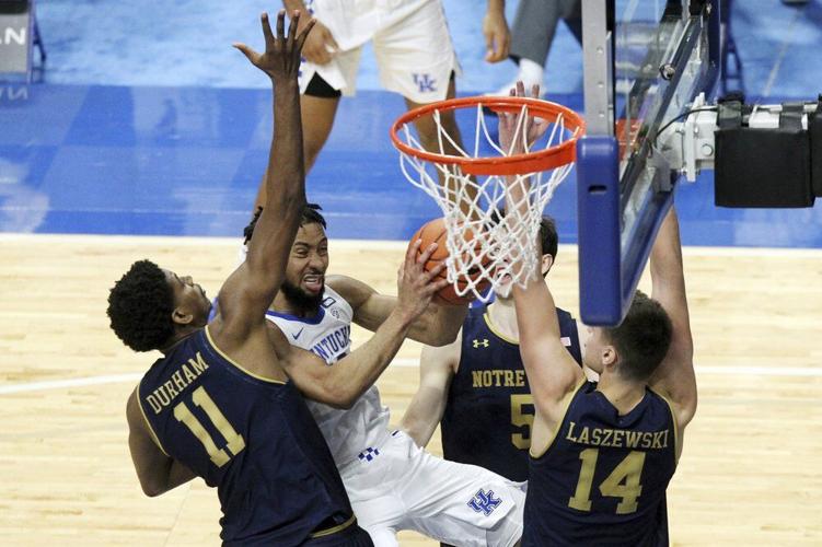 Kentucky's Davion Mintz, second from left, shoots while pressured