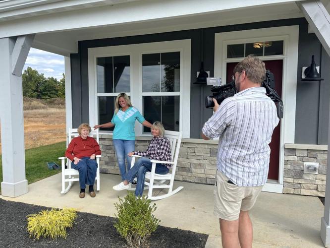 Amy Ward, St. Jude Dream Home winner, smiles on her new front porch with her mom and sister