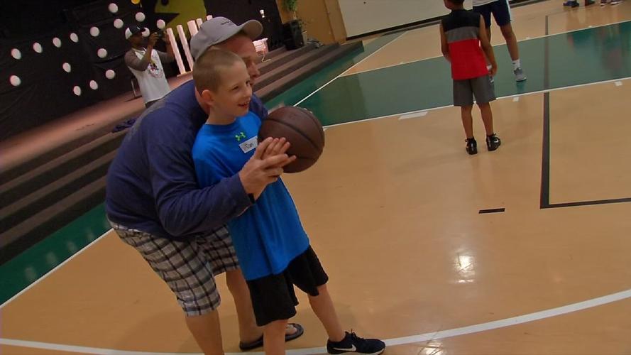 A child looks to pass a ball at Luke Hancock's basketball camp