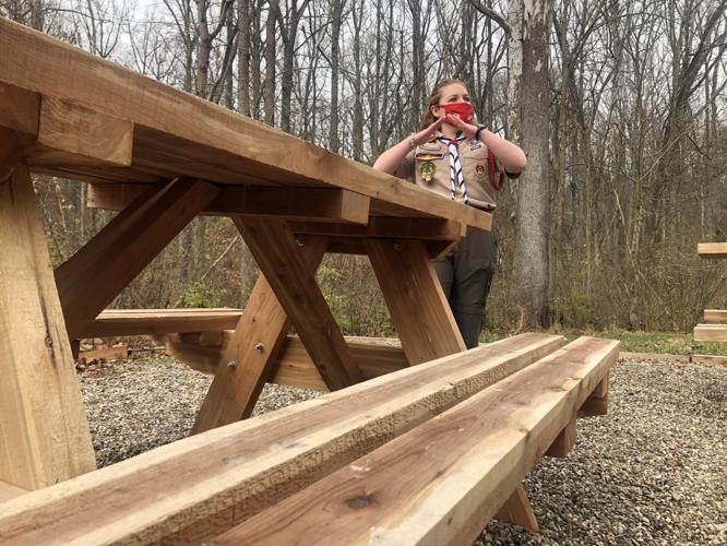 Natalie stands beside one of her picnic tables