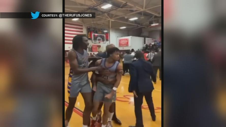 Aaron Bradshaw holding back D.J. Wagner during a fight in a New Jersey basketball game