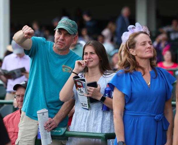 Man points to the horses.JPG