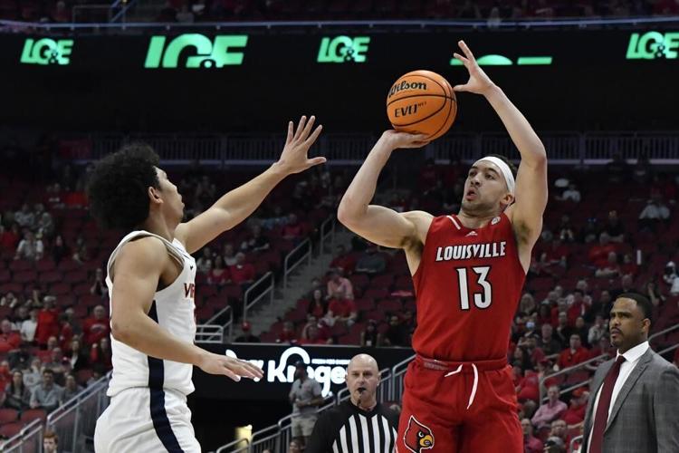 Louisville guard Jarrod West shoots over Virginia guard Kihei Clark.jpeg