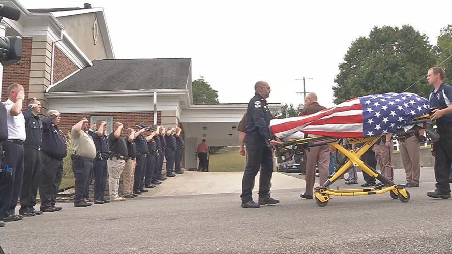 Law enforcement officers salute fallen deputy