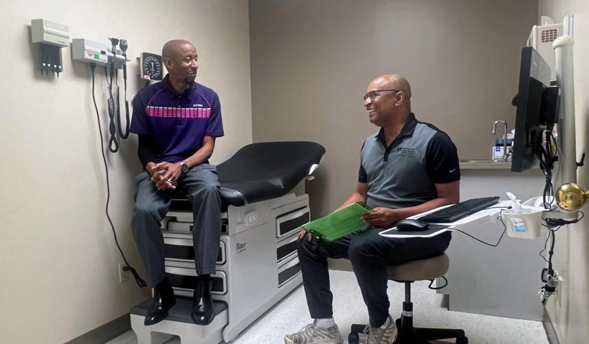 Norton Healthcare therapist Jonathan White (right) meets with Kary Goff (left), a patient
