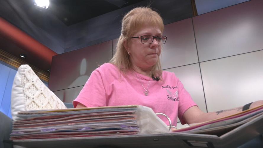 Serenity McKinney's paternal grandmother, Melody Roller, looks through a scrapbook filled with pictures of her granddaughter.