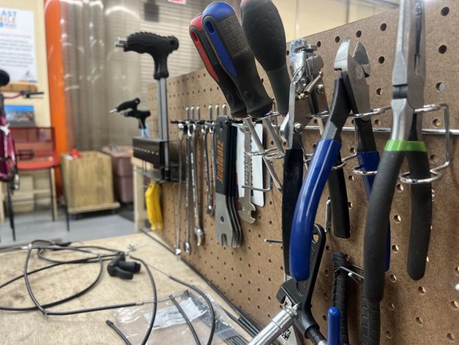 Staff use a variety of tools to repair bikes