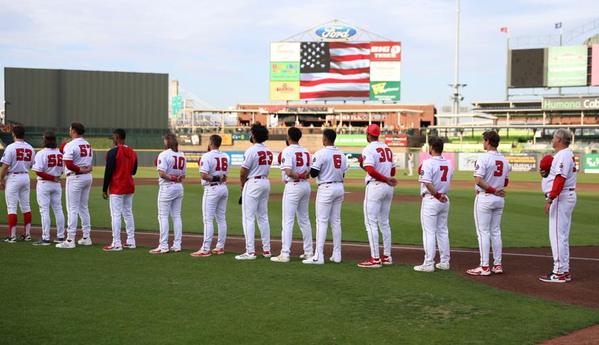 Louisville Bats stand on foul line.JPG