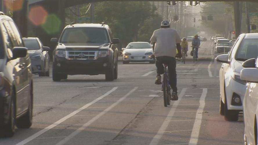 Bikers ride through a Louisville, Ky., street