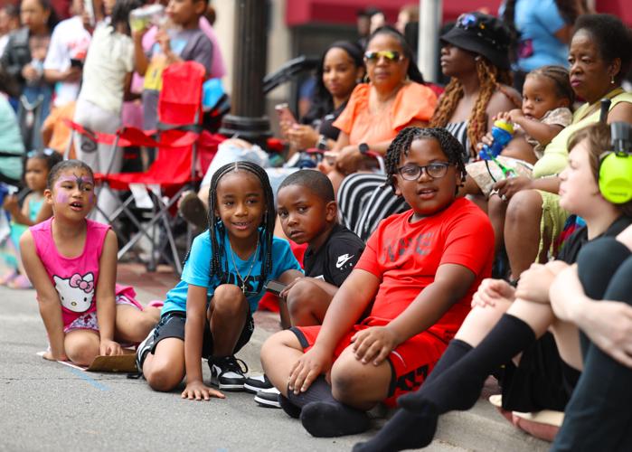 Children sit and watch Pegasus parade.JPG