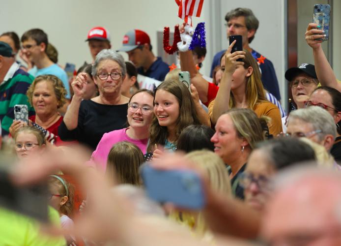 Young girls look on veterans at Honor Flight Return Home.JPG