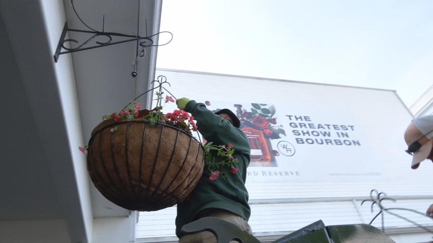 Crews place flowers around the Churchill Downs property ahead of Derby 149