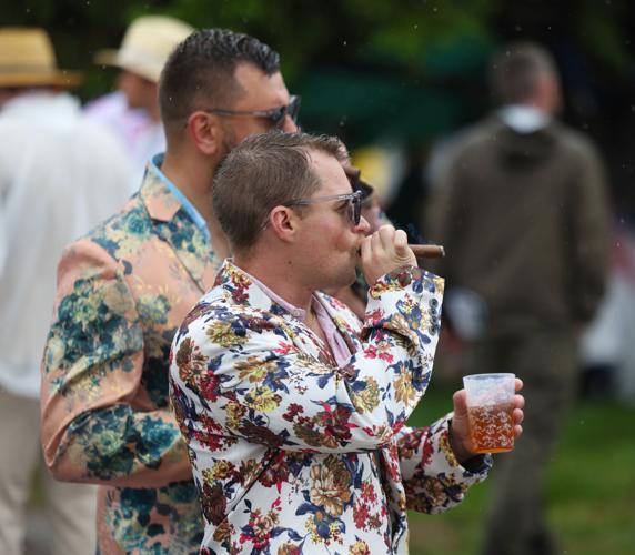 Man smokes cigar infield.JPG