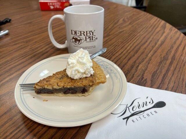 Derby Pie slice with whipped cream on a dish