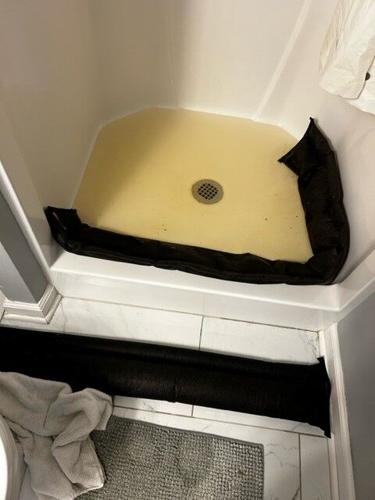 Water rises in a shower in a New Albany home after flooding on Feb. 3, 2023