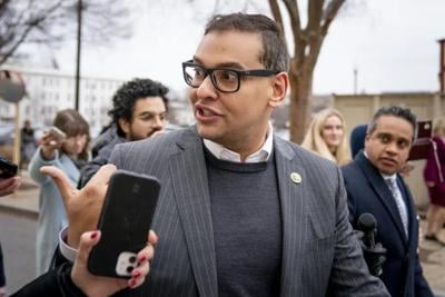US Rep George Santos talks to reporters