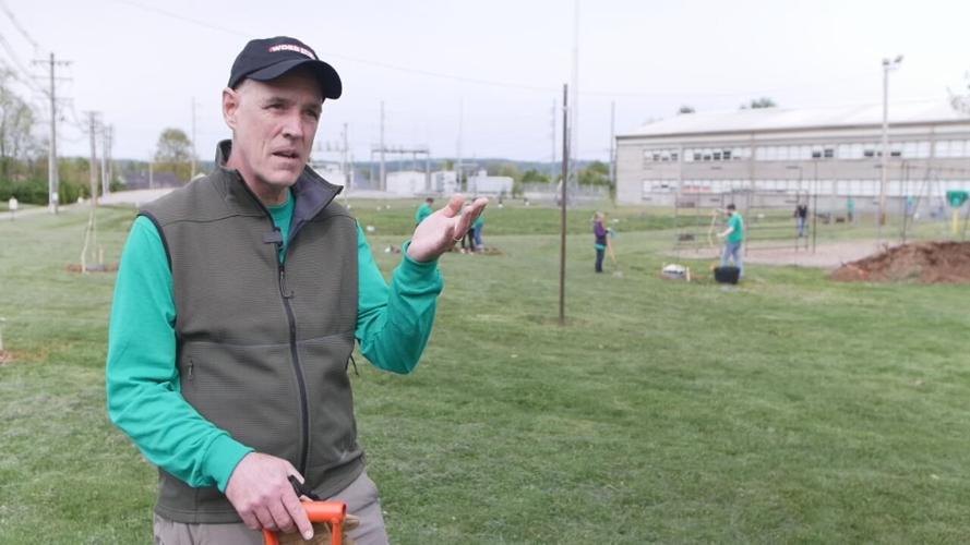 WDRB employees plant trees at Sanders Elementary School in effort to