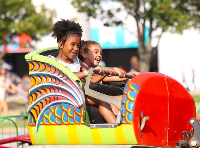 Two girls smile while riding a ride.JPG
