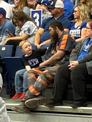 Man and son attending University of Kentucky basketball scrimmage