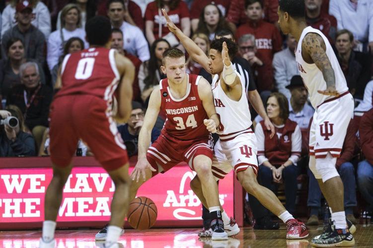 Wisconsin guard Brad Davison (34) backs into Indiana guard Rob Phinisee