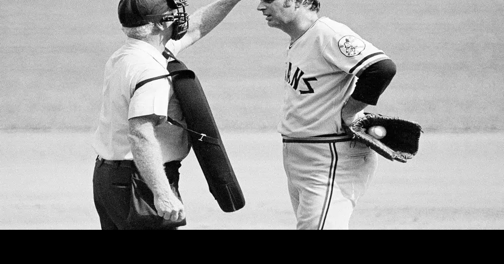 Home plate umpire John Flaherty checks Cleveland Indians pitcher