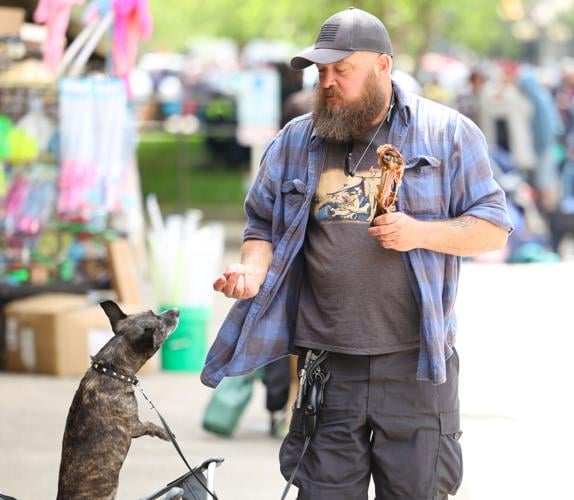 Man feeds dog turkey leg.JPG