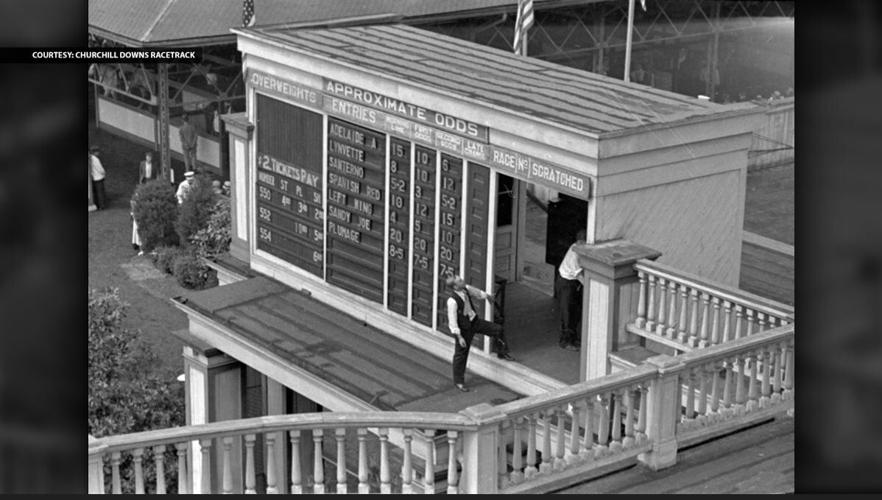 1934_Derby_007 – “Men change the tote-board in the paddock area to reflect the second race on Kentucky Derby day.”