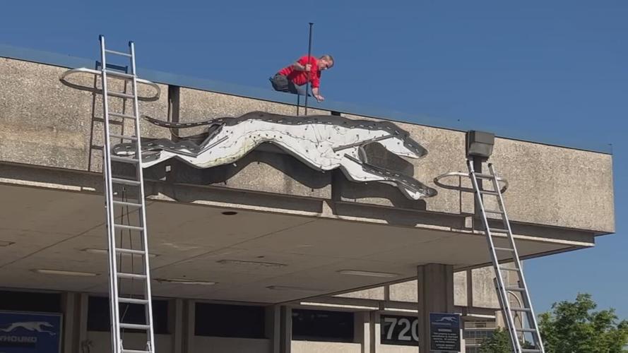 Crews removing sign from former site of Greyhound bus station in downtown Louisville