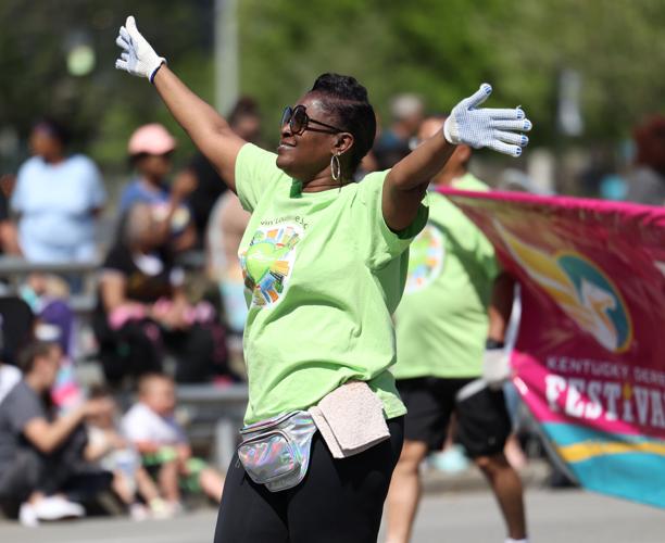 Woman waves to the crowd at the 2022 Pegasus Parade