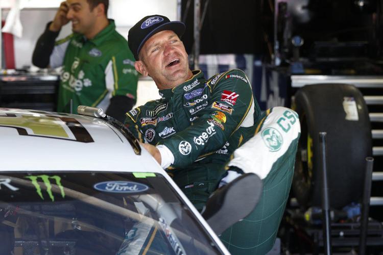 Clint Bowyer gets in his car during practice