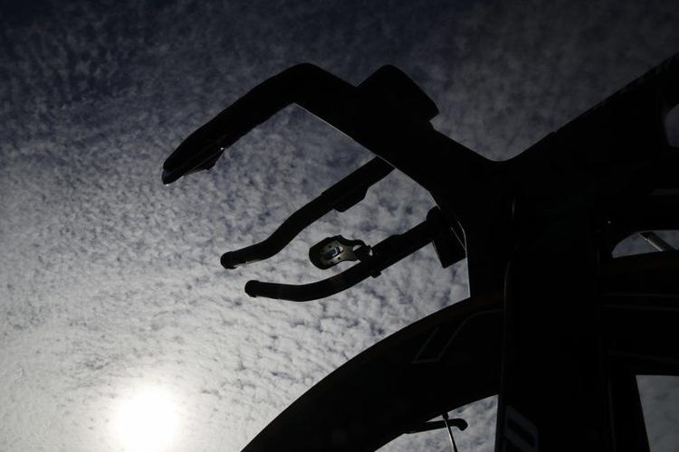 A bicycle is silhouetted by sunlight