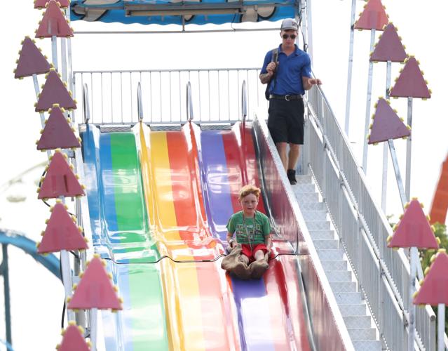 Boy goes down slide at state fair