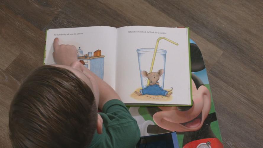 Child reads from story book
