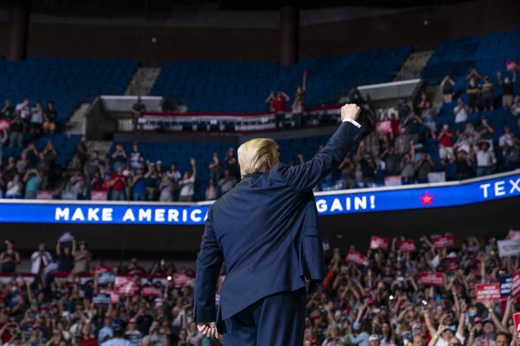 President Donald Trump arrives on stage to speak at a campaign rally at the BOK Center
