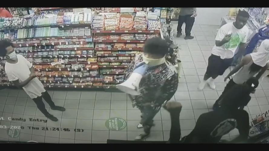 People gather in Bader's Food Mart in response to shooting