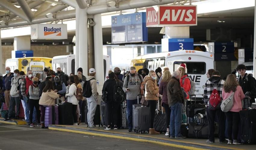 Travelers wait for shuttles at Denver airports