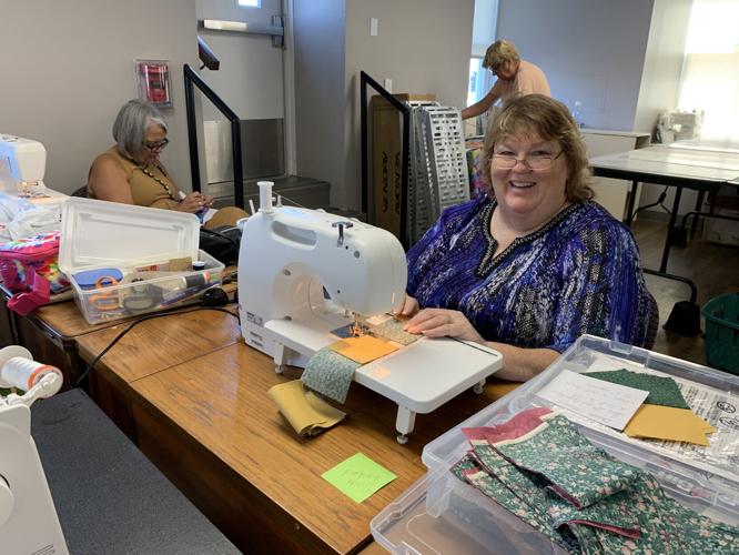 Women from the St. Joseph Ladies Sewing Society sew quilts for the St. Joseph Children's Home