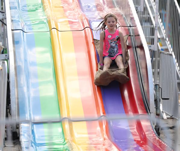 Girl goes down slide at state fair