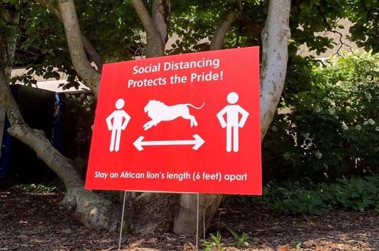 A sign encouraging social distancing at the Louisville Zoo